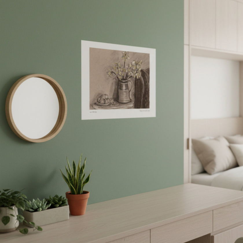 A sepia-toned still life art print depicting a vase of flowers and a bowl of eggs, hanging on a green wall in a styled room with pot plants, mirror and window