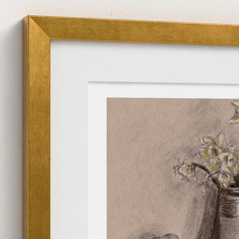 Close-up of a framed art print with a textured gold frame, white mat, and a charcoal sketch of yellow flowers in a vase on a beige background.