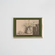 A card featuring a monochrome still life sketch of flowers and eggs, mounted on a brown kraft envelope against a light gray background.