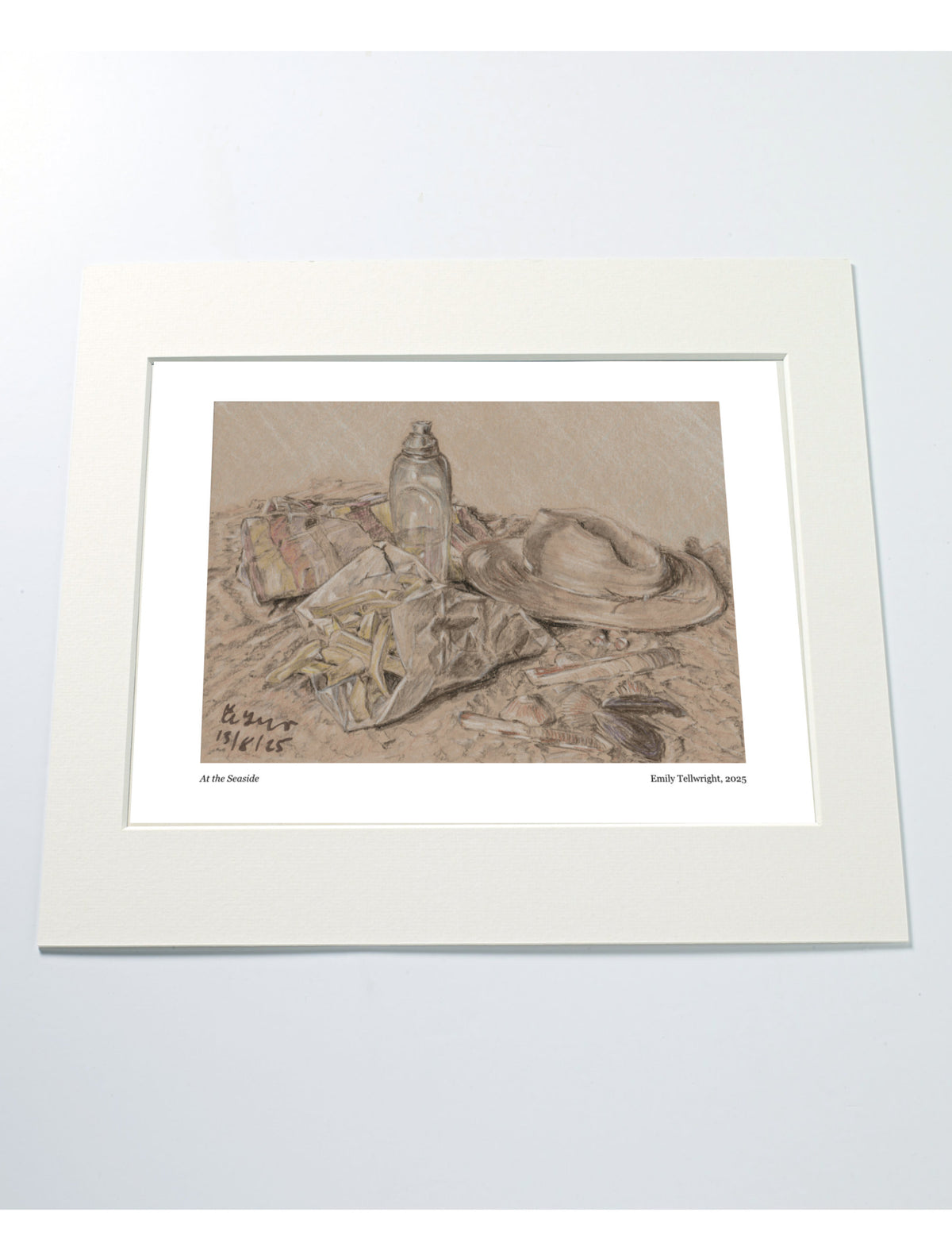 a mounted art print of a drawing of a beach scene with hat, water bottle towel and chips