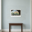 An art print of Biddulph Grange on a blue wall above a dark wood table