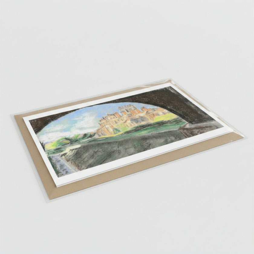 A greetings card showing a landscape painting of Biddulph Grange, photographed on a clean light gray background. The card has an envelope and clear sleeve, with visible painterly colours including blue, green, grey, and beige.