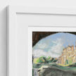 A close-up of a framed art print showing part of a pastel landscape drawing with a Biddulph Grange, trees, and sky, set in a white frame against a white wall.