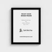 a black wooden picture frame with a castle sefton press logo