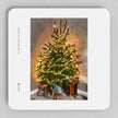 A square coaster with rounded corners featuring an oil painting of a decorated Christmas tree. The print is displayed on a neutral gray background.