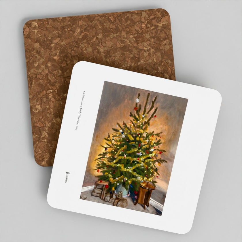 Two square coasters on a light gray background, with one coaster showing a printed Christmas tree artwork and the other showing the brown cork-like textured reverse side.