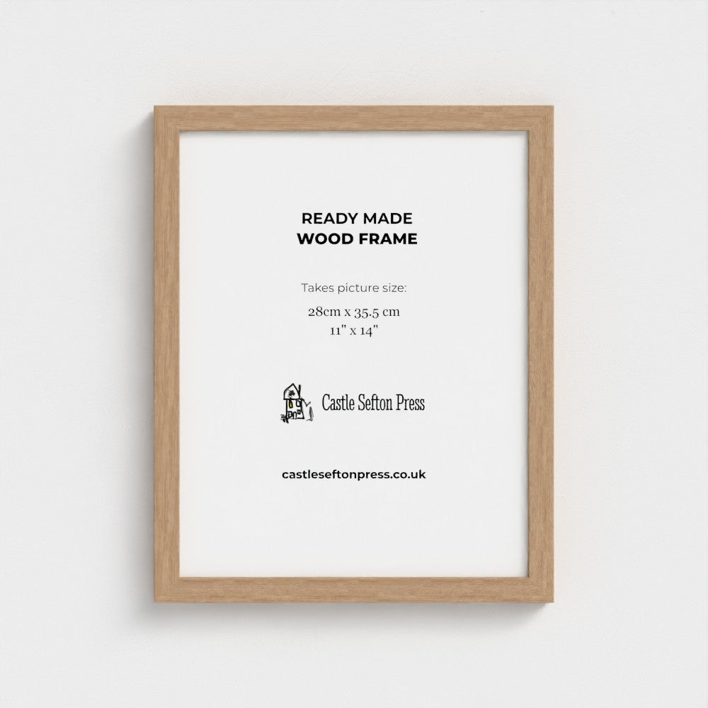 A light natural wood picture frame with a white mat, displaying product information text for Castle Sefton Press, shown against a neutral light grey background.