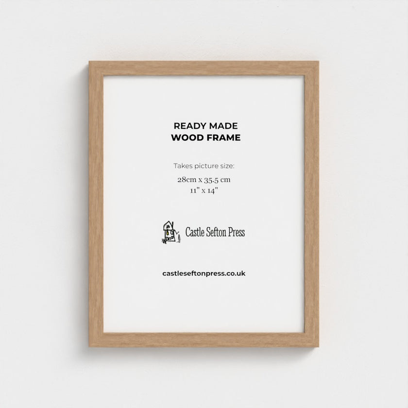 A light natural wood picture frame with a white mat, displaying product information text for Castle Sefton Press, shown against a neutral light grey background.
