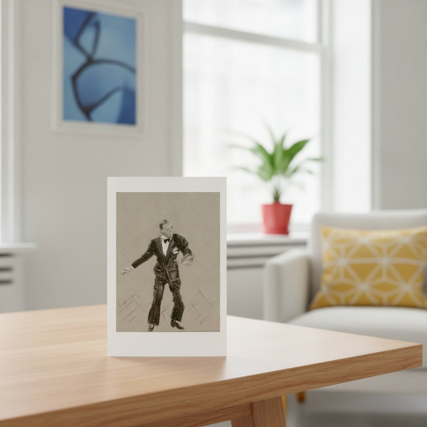 A greetings card featuring a black and white sketch of Fred Astaire, displayed on a wooden table in a bright, modern living room setting.