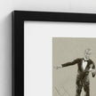 A framed art print featuring a black-and-white sketch of a man in a tuxedo, shown in a close-up view with a black frame and white mat against a light wall.