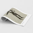 A rolled-out art print or poster showing a monochrome sketch of a figure in motion, photographed on a clean light gray background.