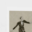 A square art print featuring a sepia-toned sketch of a man in a tuxedo with arms outstretched, shown against a white border on a light textured background.