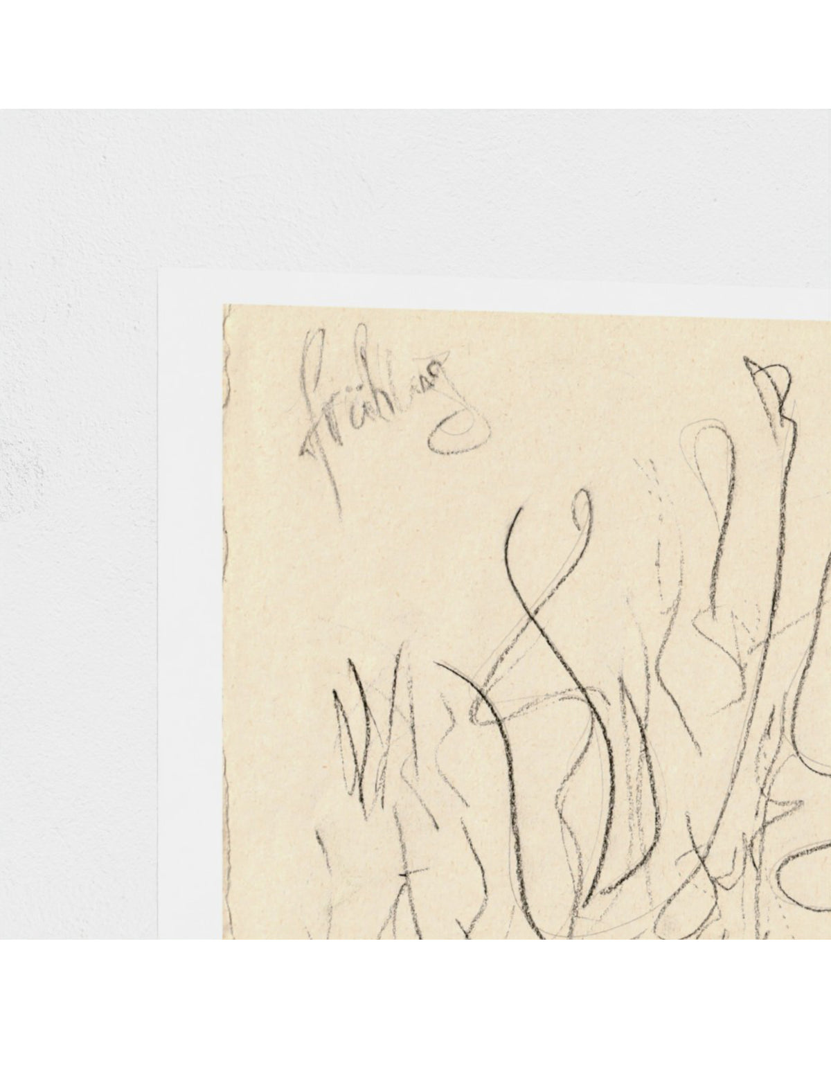 A close-up of an abstract art print featuring black ink scribbles on textured beige paper, set against a clean white background.