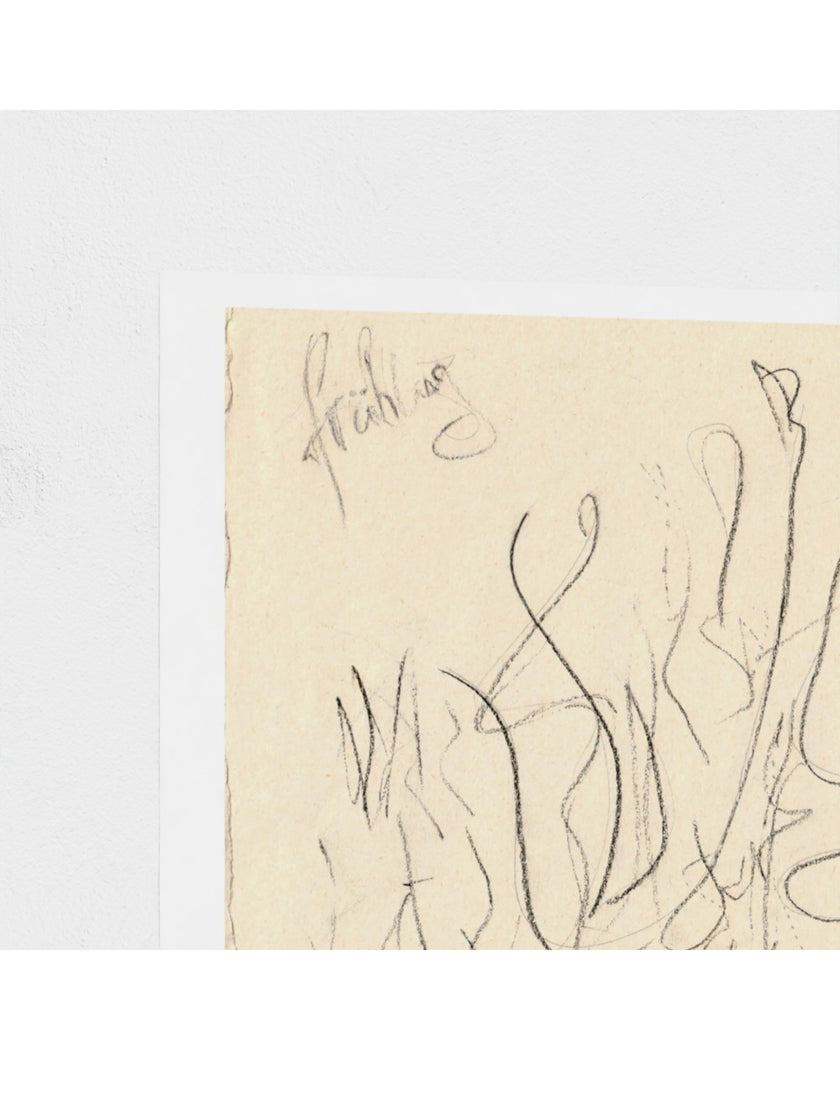 A close-up of an abstract art print featuring black ink scribbles on textured beige paper, set against a clean white background.