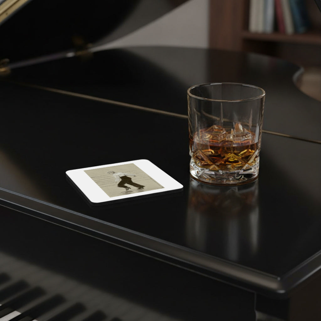 A clear square coaster with rounded corners sits on a glossy black piano lid next to a glass of whiskey with ice.