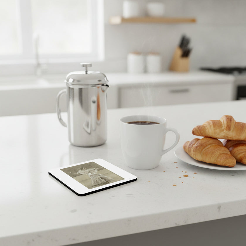 A white ceramic coffee mug with steam rising, placed on a white kitchen countertop next to a silver French press, a square coaster with a black-and-white photo print, and a plate of croissants.