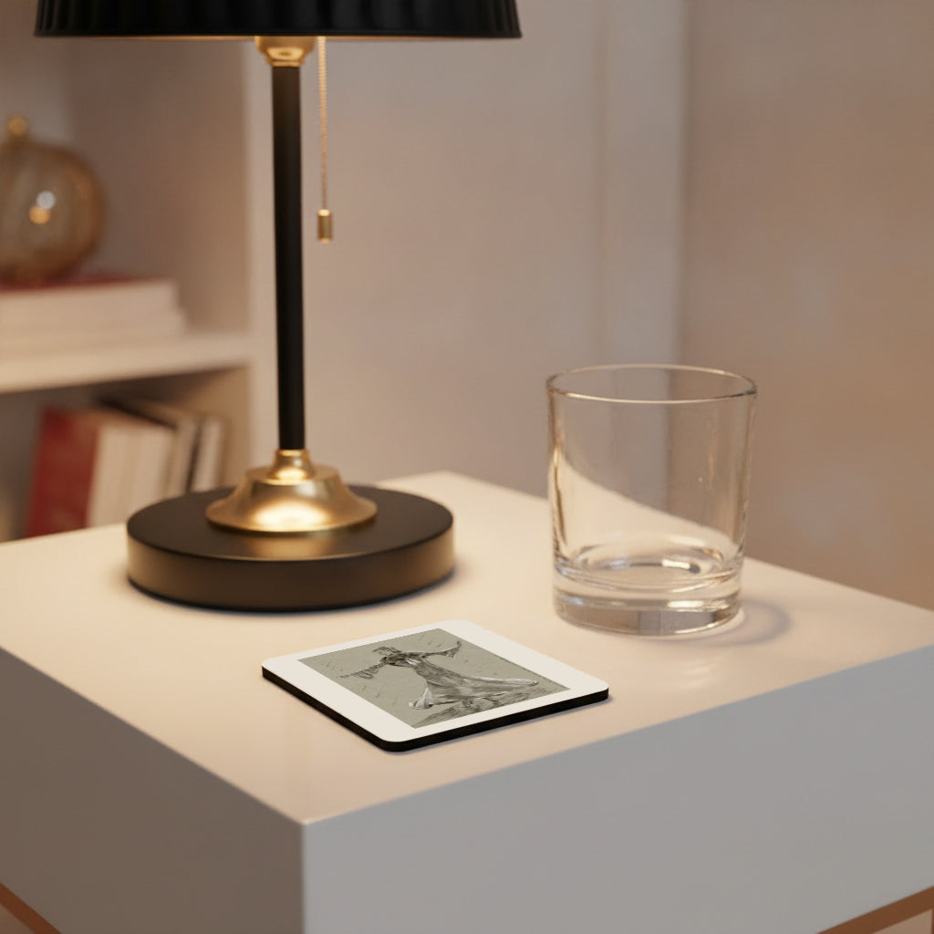 A square coaster with a black and white graphic print sits on a white side table next to a clear drinking glass and a black and gold table lamp.