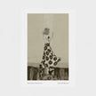 An  art print featuring a monochrome illustration of a woman in a floral dress standing on a shiny floor