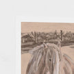 A close-up of a printed artwork showing the back of a pale horse in front of a softly sketched landscape, with a white border on a light neutral background.
