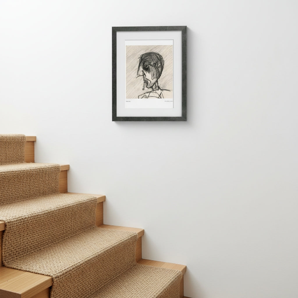 A framed black and white sketch portrait of a person hanging on a white wall above a staircase with woven carpeting.