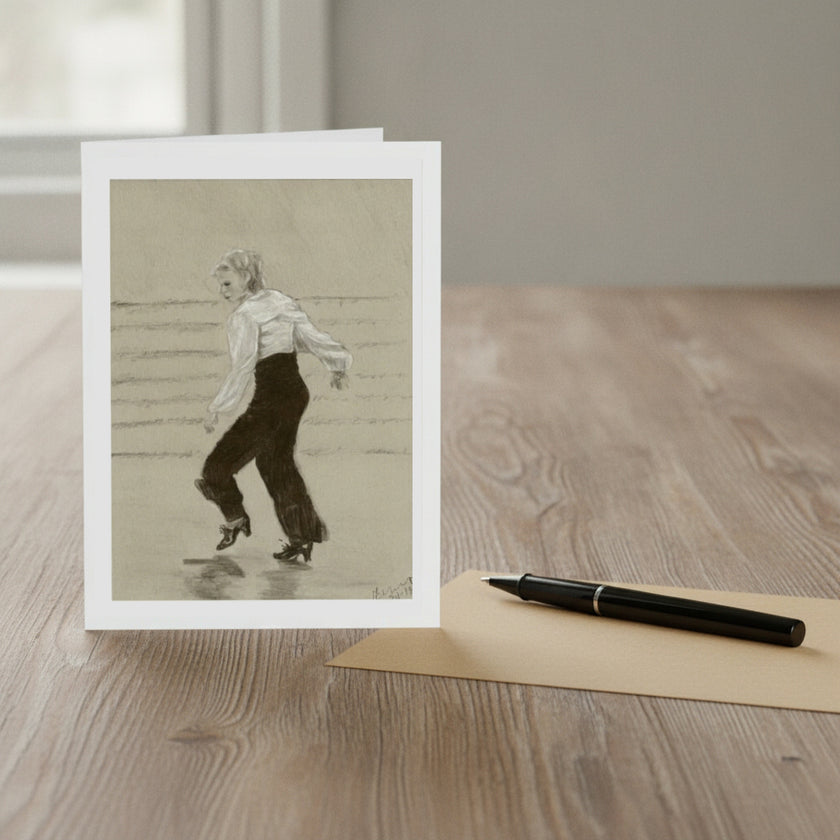 A vertical art print card featuring a black and white drawing of ginger rogers, displayed on a light wood tabletop next to a black pen and a beige envelope.