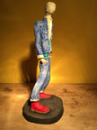 Ceramic sculpture of skinhead in green shirt