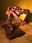 Ceramic sculpture of a rockabilly guitarist painted red.