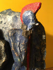 Ceramic sculpture of two punks leaning on a wall smoking.