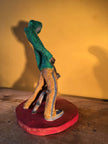 Ceramic sculpture of figure in green hoodie with a Staffordshire bull terrier on a lead.
