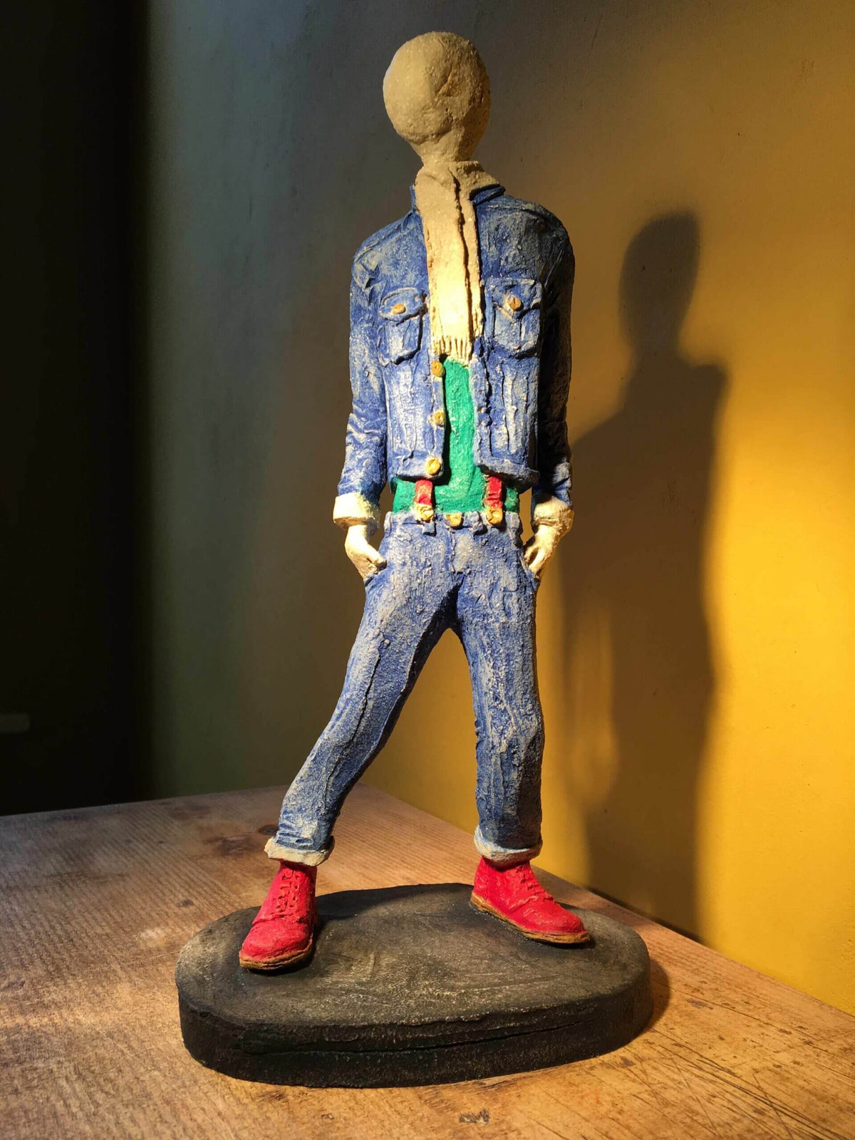 Ceramic sculpture of skinhead in green shirt
