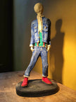 Ceramic sculpture of skinhead in green shirt