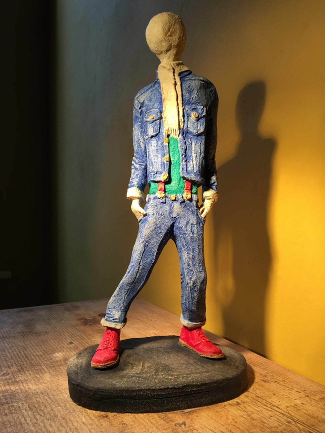 Ceramic sculpture of skinhead in green shirt