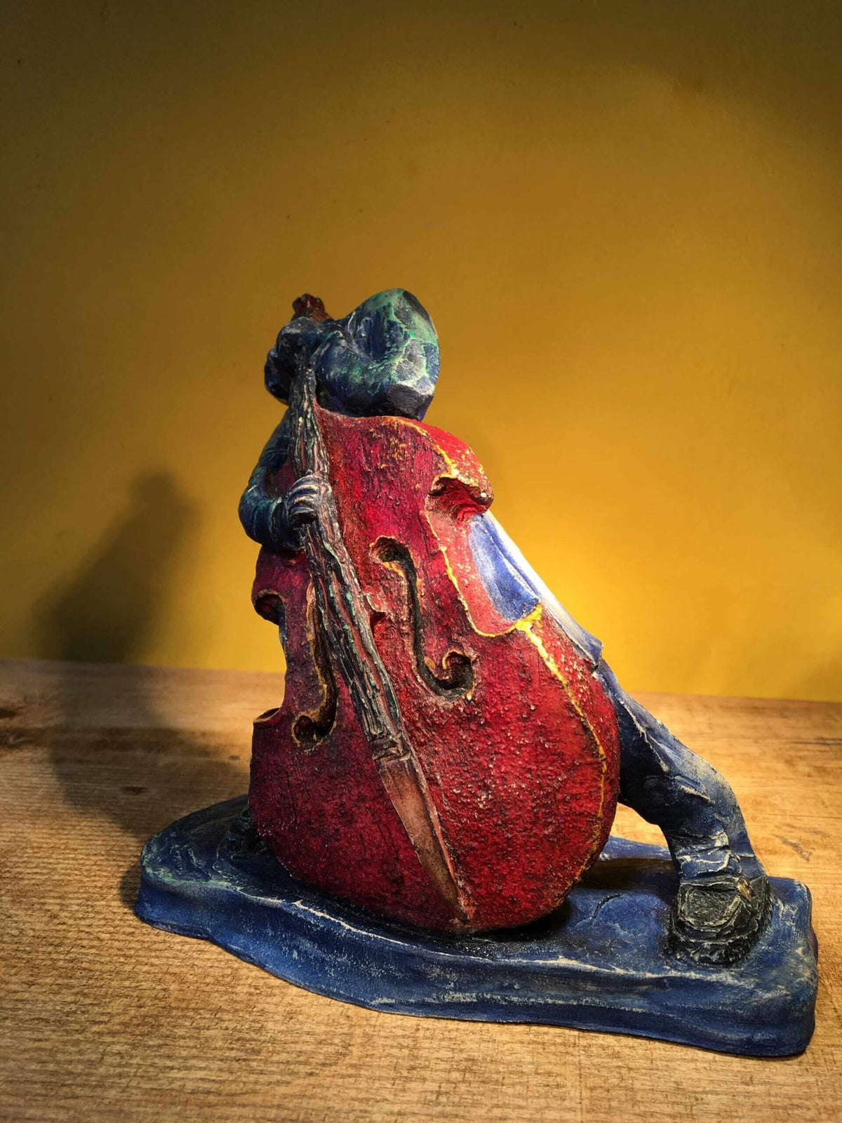 Ceramic sculpture of rockabilly bass player.