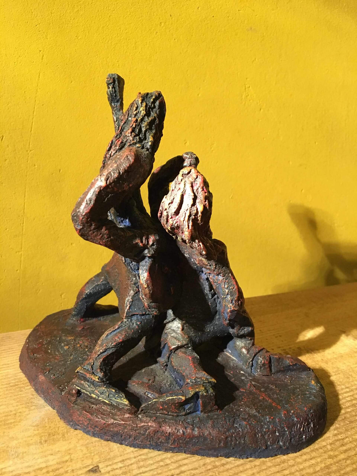 Ceramic sculpture of a singer and guitarist painted red.