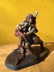 Ceramic sculpture of a singer and guitarist painted red.