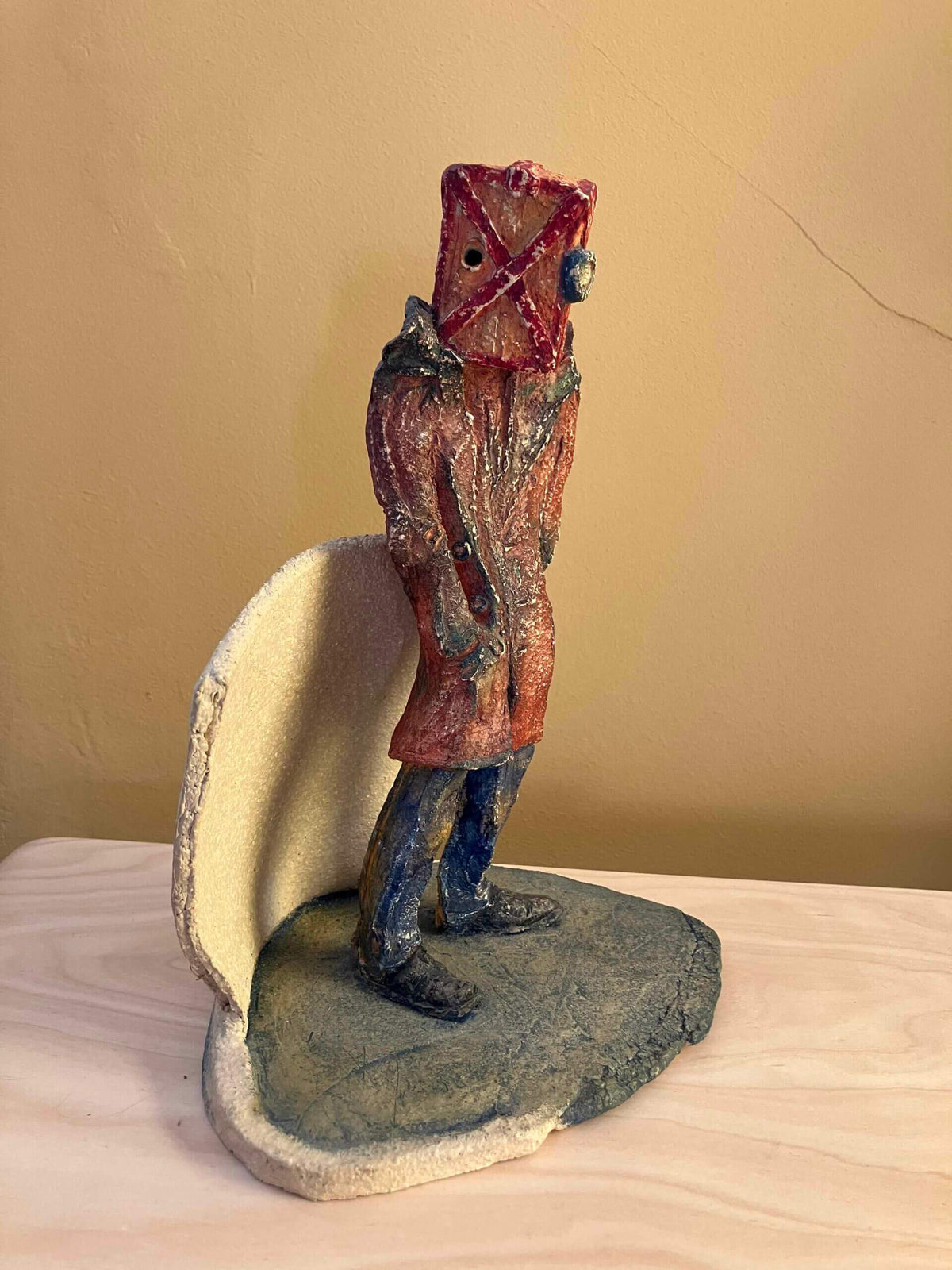 Waiting Room surrealist sculpture of a figure with a box and goggles on its head