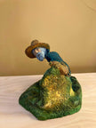 Ceramic sculpture of a Pilgrim Father hunter pointing a gun.
