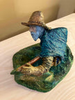 Ceramic sculpture of a Pilgrim Father hunter pointing a gun.