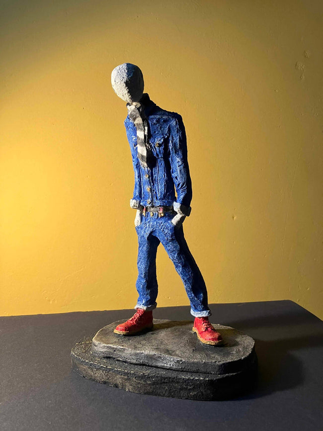 Ceramic sculpture of a skinhead in a black-and-white scarf