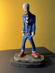 Ceramic sculpture of a skinhead in a black-and-white scarf