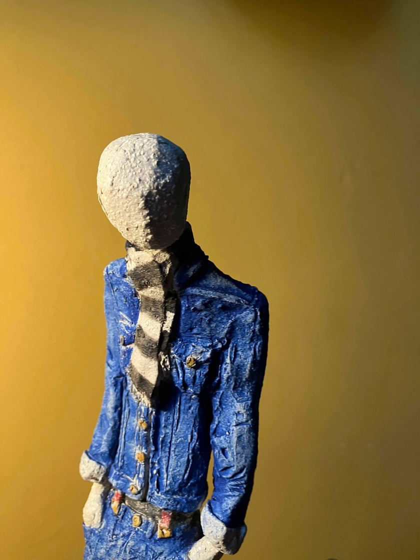 Ceramic sculpture of a skinhead in a black-and-white scarf