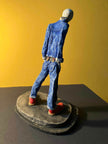 Ceramic sculpture of a skinhead in a black-and-white scarf