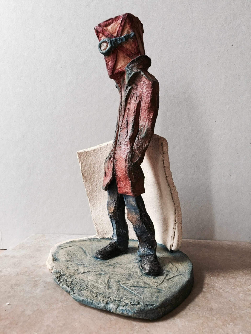 Waiting Room surrealist sculpture of a figure with a box and goggles on its head