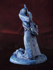 Ceramic sculpture of a kneeling guitarist painted blue.