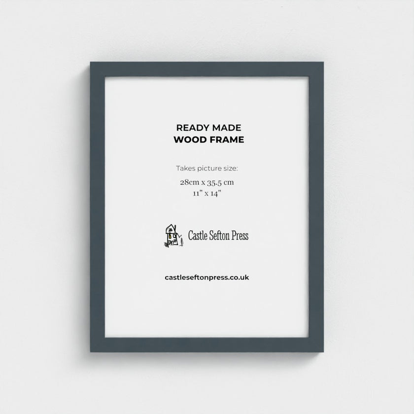 A light natural wood picture frame with a white mat, displaying product information text for Castle Sefton Press, shown against a neutral light grey background.