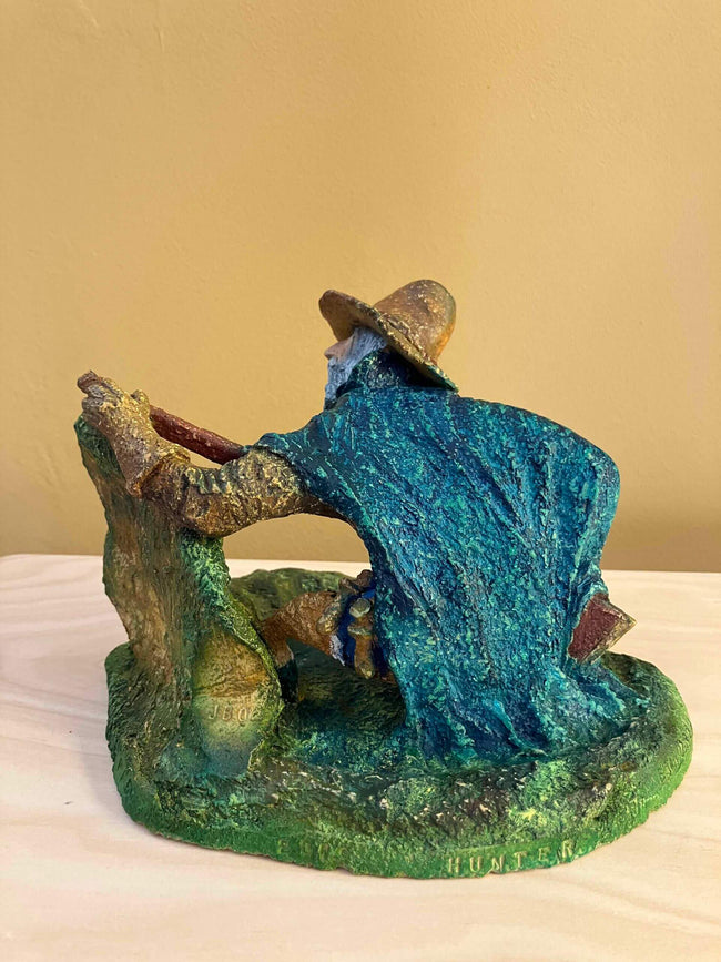 Ceramic sculpture of a Mayflower Pilgrim hunter pointing a gun.
