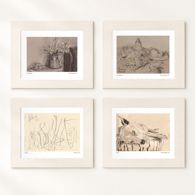 Four mounted art prints arranged in a 2x2 grid on a light beige wall with soft diagonal shadows. 