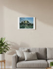 Winter Sun Through Trees Art Print shown on a cream wall above a beige couch
