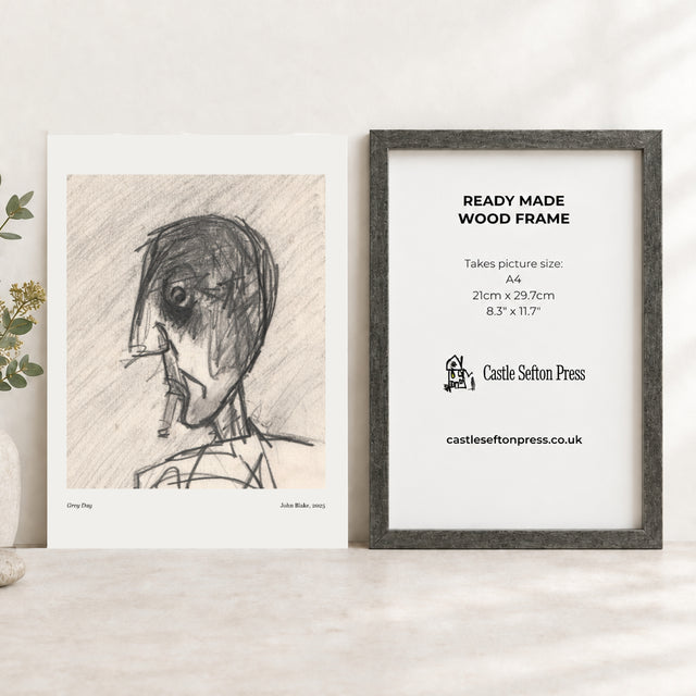 an art print of a head smoking next to an antique silver picture frame