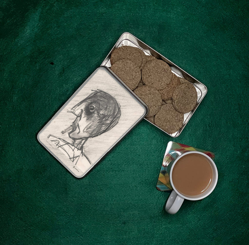 Grey Day Storage tin filled with biscuits next to a mug of tea